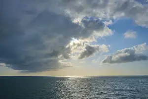 Uninhabited Coastal View Prints: Fresh view of clouds and light above sea surface