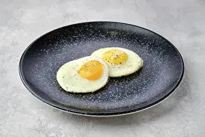 Fried Eggs Prints: Two fried eggs on a plate