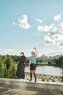 Fashionable Women Prints: Two friends stand by water at city park