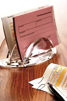 Cashless Payment Prints: Funds transfer form and a pen, more forms in background