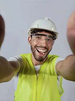 Construction Worker Photo Prints: Funny builder engineer taking a selfie isolated