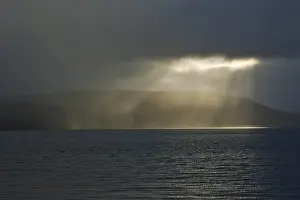 Deserted Icelandic Coastline Prints: Gap in the clouds with sun shining through