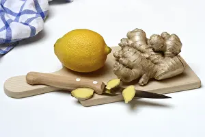 Nutrition Facts Ginger Prints: Ginger root and lemon on kitchen board with knife