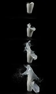 Healthy Eating Symbolism Prints: Glass for Milk exploding against Black Background