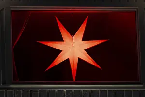 European Winter Scenes Prints: Glowing advent star in a window