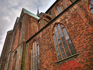 German Federal Republic Old Town Prints: Gothic cathedral made of red bricks with high windows under a cloudy sky