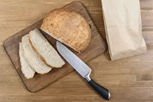 Homemade Bread Prints: Grain bread is sliced on the Board