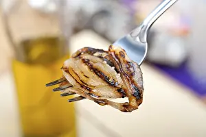 Olive Oil Nutrition Facts Prints: Grilled onion on a fork macro close up