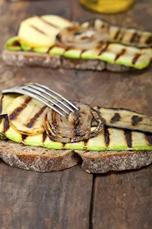 Gourmet Meal Ideas Prints: Grilled vegetables on rustic bread over wood table