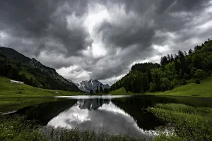 Central Europe Countryside Photo Prints: Groppelensee with reflection of the Altmann summit in the background under a threatening cloudy sky