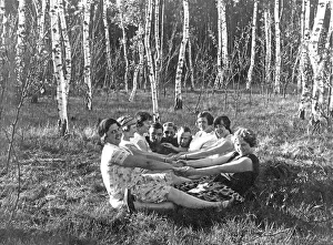Man And Woman Sitting Together Prints: Group in the forest holding hands