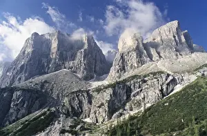 Deserted Mountain Scenery Prints: Group of jagged mountains rand thin clouds