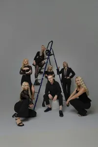Elegant Studio Setting Prints: A group of seven individuals is posing elegantly in a studio setting