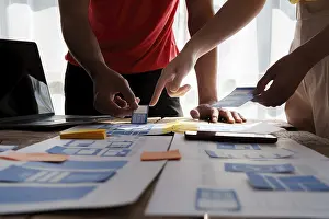 Ux Design Brainstorming Prints: Group of ux developer and ui designer brainstorming about app interface design at modern office