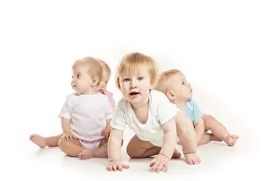 White Background Kids Prints: Group of witty babies sitting in different clothes