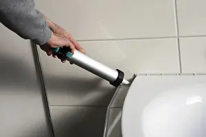Construction Worker At Site Prints: Grouting work. Tiler grouting in a new bathroom