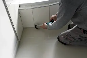 Ceramic Tile Installation Prints: Grouting work. Tiler grouting in a new bathroom