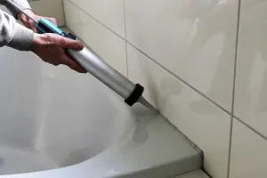 Ceramic Tile Installation Prints: Grouting work. Tiler grouting in a new bathroom