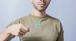 Personal Hygiene Practice Prints: Guy with unrecognizable face holds brush with toothpaste on isolated background