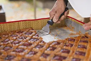 Southern Germany Food Photography Prints: Hand cut a raspberry pastry with a scraper on a baking tray
