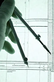 Construction Blueprint Details Prints: Hand with dividers on a construction plan