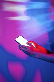 Neon Smartphone Prints: A hand interacts with a smartphone
