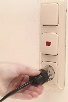 Accident Prevention Tips Prints: Hand pulls plugs from plug socket