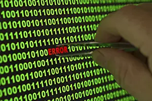 Data Security Breach Prints: Hand reaching for the word 'Error' with tweezers in a binary code Hand reaching for the word