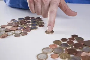 Saving Money Tips Prints: Hand sorting coins