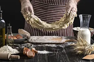 Flour Products Prints: A handful of flour with egg on a rustic kitchen
