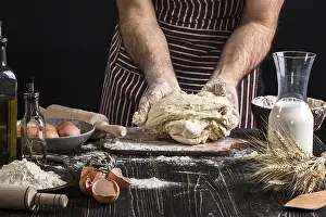 Flour Products Prints: A handful of flour with egg on a rustic kitchen