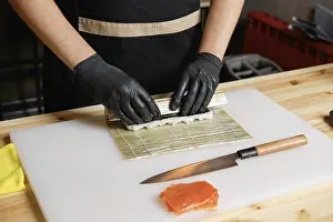 Gourmet Meal Preparation Prints: Hands of chef making salmon rolls