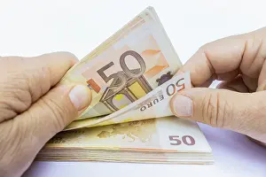 Payment Transaction Prints: Two hands counting stack of 50 euro notes