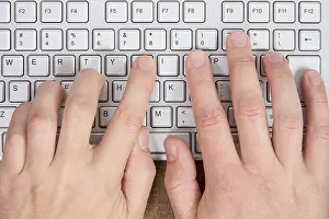 Empty Workspace Prints: Hands typing on a computer keyboard