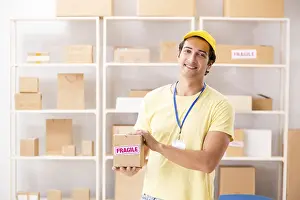 Handsome Contractor Prints: Handsome contractor working in box delivery relocation service