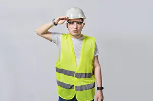 Young Engineer Prints: Handsome engineer looking into the distance isolated