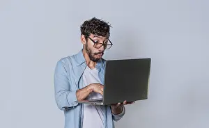 Hispanic Entrepreneur Prints: Handsome guy checking his laptop isolated