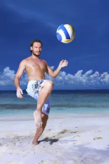 Prints of Handsome man is playing on the beach Related Prints: Handsome Man Playing on the Beach Print