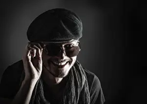 Architectural Style Photography Prints: Handsome young man posing with a hat