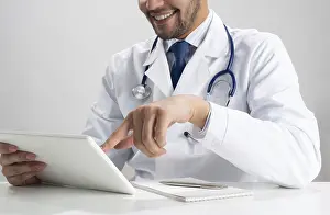 Young Doctor Prints: Happy young doctor using tablet computer