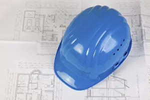 Deserted Construction Site Europe Prints: Hard hat lying on a construction plan