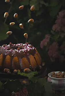 Dark Food Photography Prints: Hazelnut cake, flying hazelnuts
