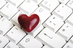 Red Coloured Heart Shape Prints: Heart lying on a computer keyboard