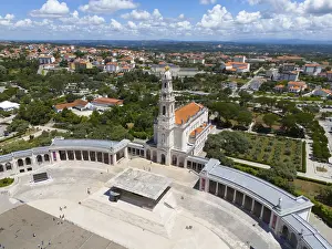 Fatima Pilgrimage Site Prints: High angle shot of a basilica with a large square surrounded by green trees