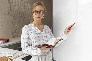 Educational Institution Photography Prints: High angle teacher with book explaining lesson