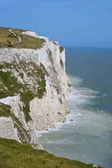 Uninhabited Rocky Shoreline Prints: High cliffs falling dramatically into the sea under a clear sky