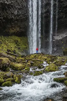 Rocky Outcrop Landscape Prints: Hiker in front of a high waterfall