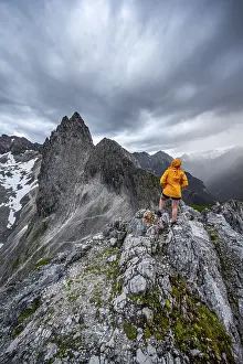 Wetterstein Mountains Scenery Prints: Hiker looking at mountains under dramatic clouds
