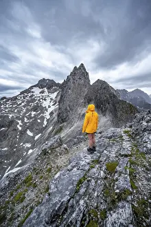 Wetterstein Mountains Prints: Hiker looking at mountains under dramatic clouds
