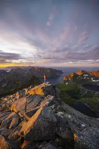 Female Hiker Norway Prints: Hiker stands at the summit, sunset with dramatic clouds